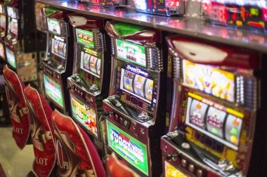 Slot game interface on mobile phone showing reels and bet controls